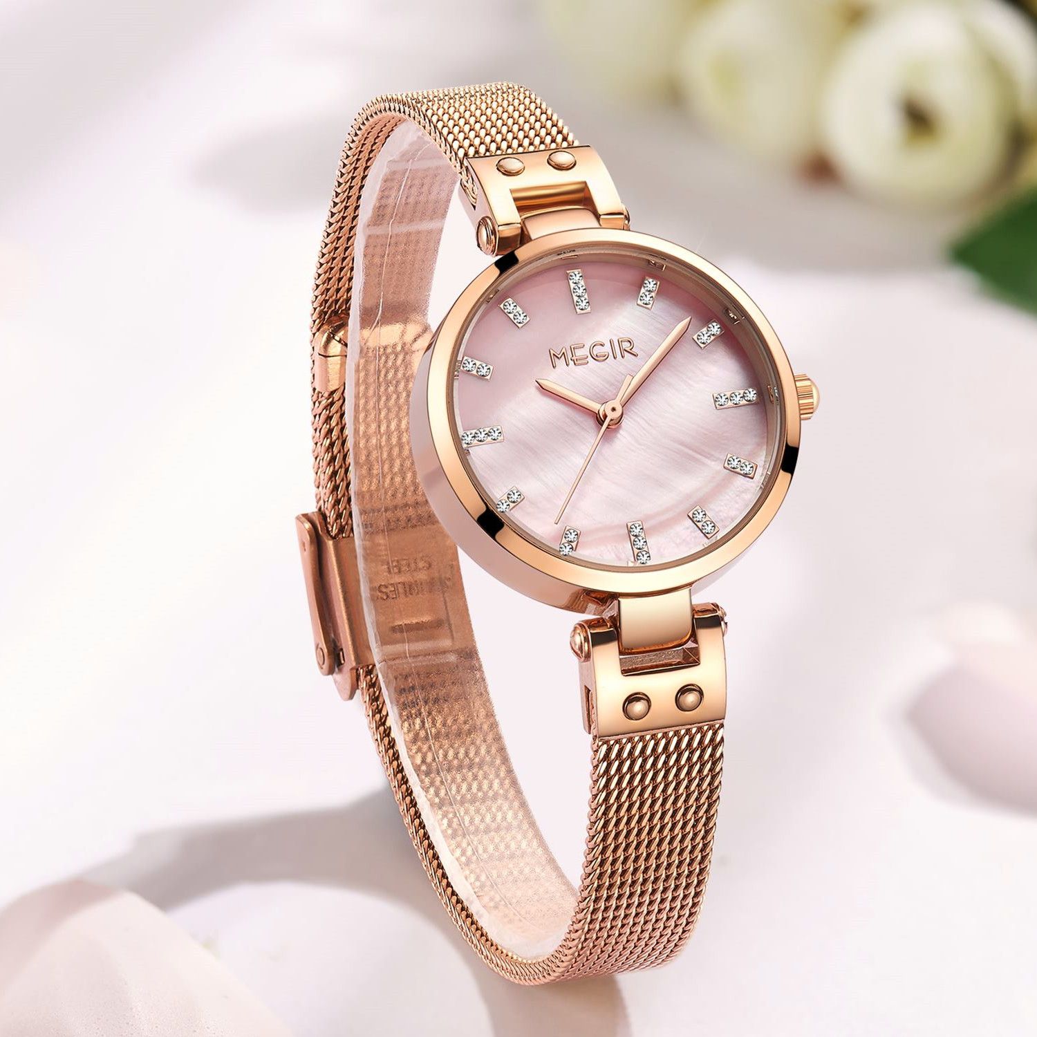 MEGIR 7025 women's quartz watch, pink dial and rose-gold mesh bracelet, styled on white petals