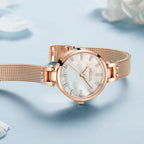 MEGIR 7025 women's quartz watch, white dial and rose-gold mesh bracelet, styled side view