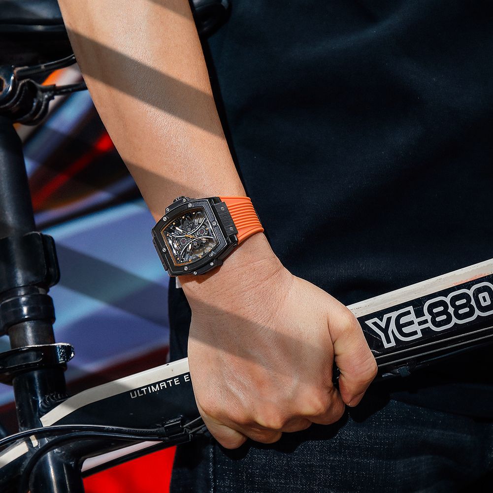 MEGIR 8109 skeleton quartz watch on the wrist, black case, orange-accent skeleton dial and orange silicone strap