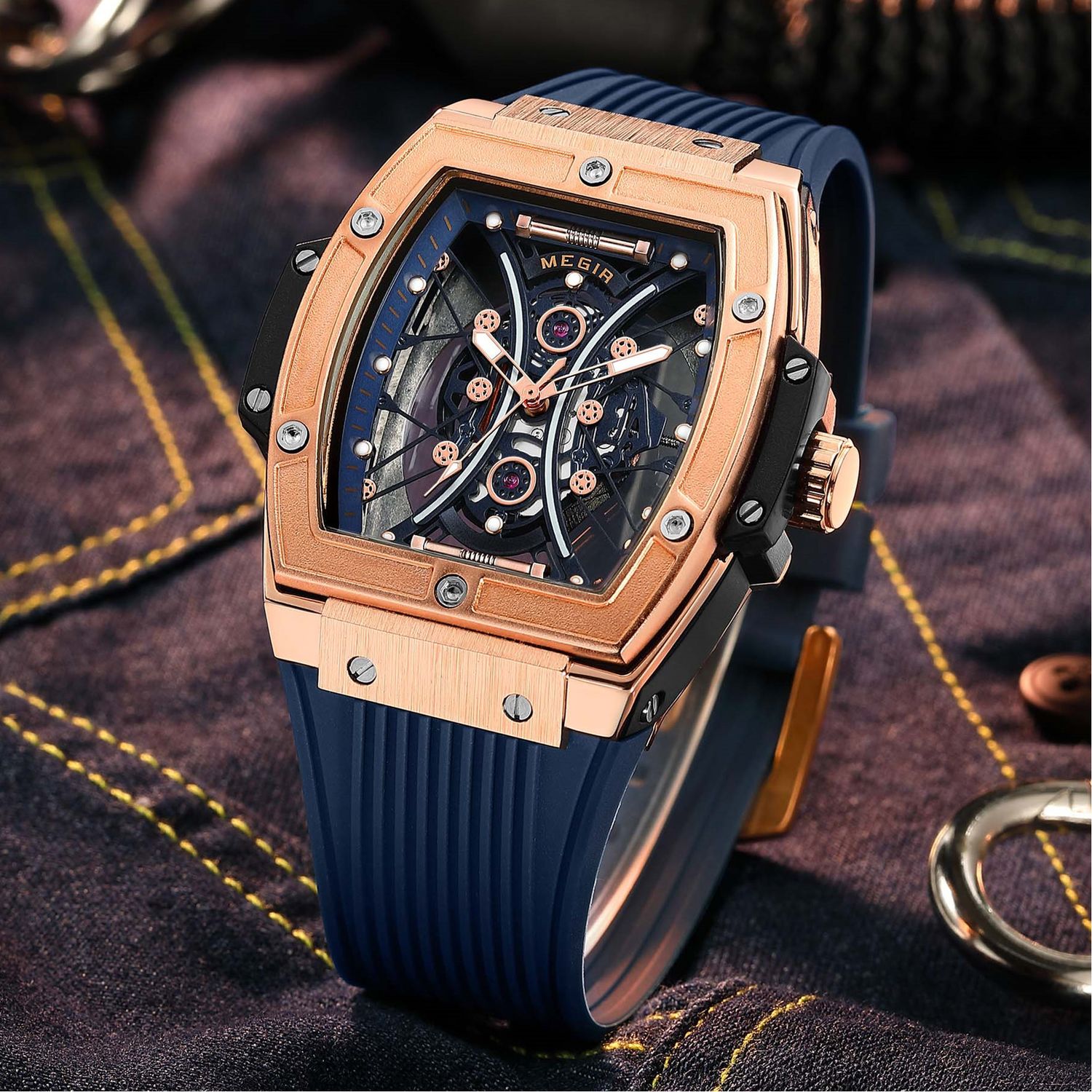 MEGIR 8109 skeleton quartz watch, rose-gold case, blue skeleton dial and blue silicone strap, styled on fabric