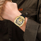 MEGIR 8112 chronograph watch on the wrist, gold tonneau case, black skeleton dial and black silicone strap