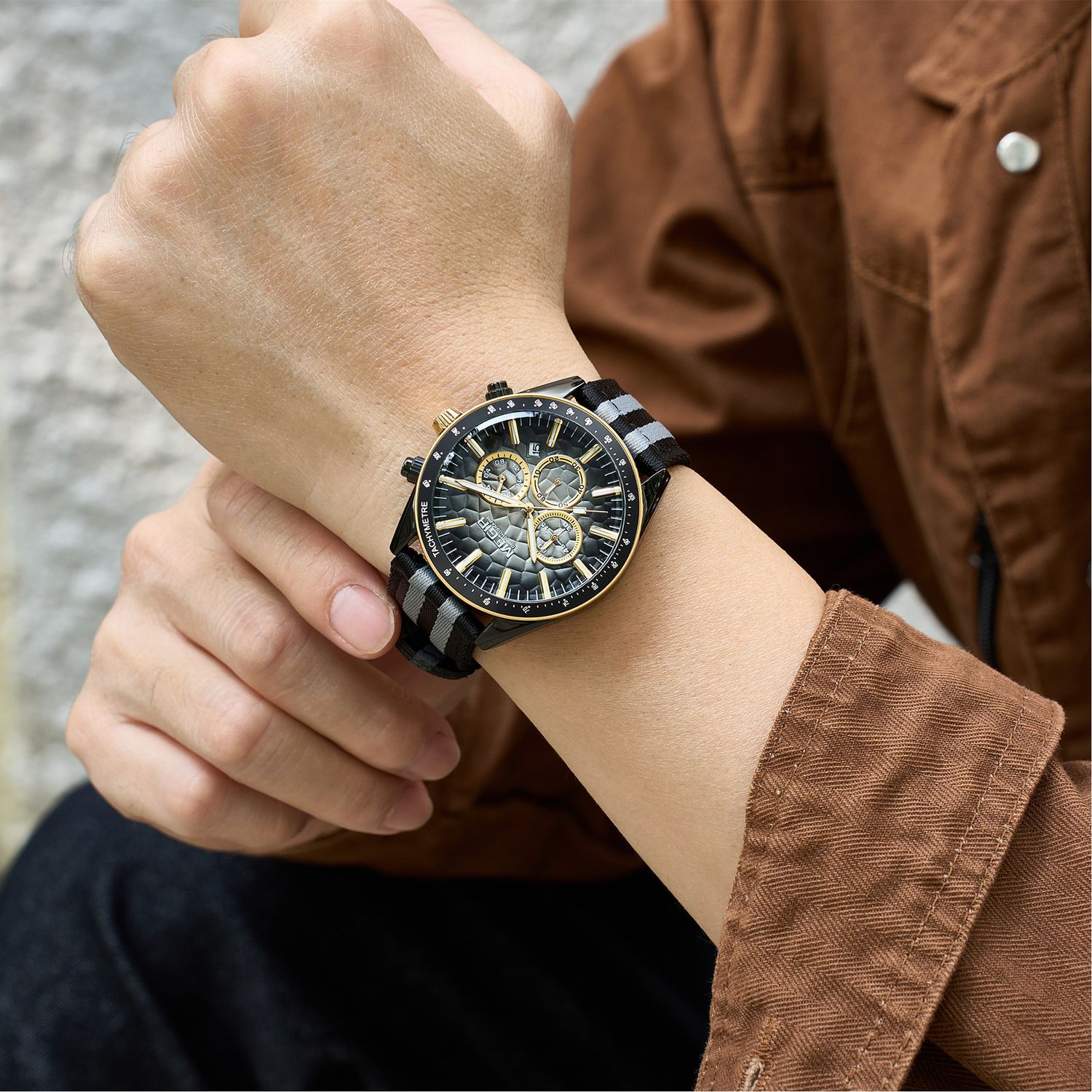 MEGIR 8121 chronograph watch on the wrist, black case, grey dial with gold accents and black-grey nylon strap