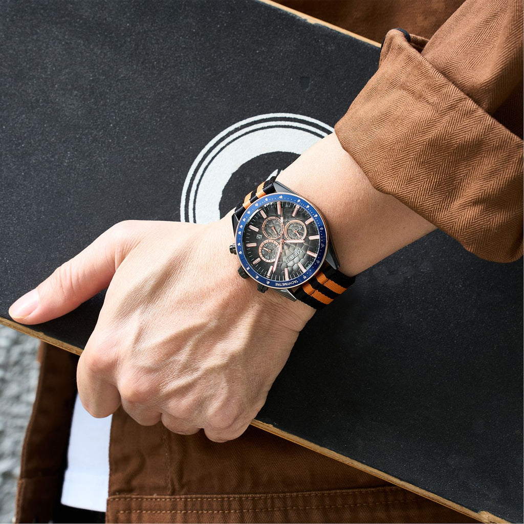 MEGIR 8121 chronograph watch on the wrist, black case, dark dial and black-orange nylon strap