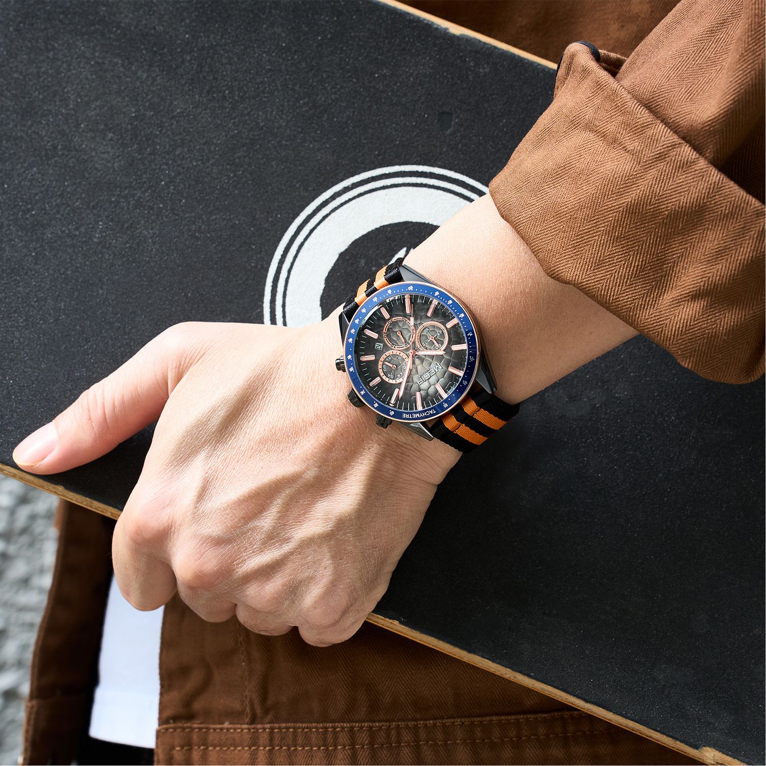 MEGIR 8121 chronograph watch on the wrist, black case, dark dial and black-orange nylon strap