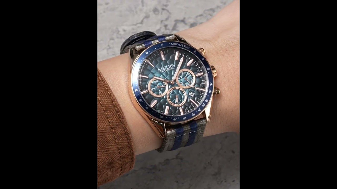 MEGIR 8121 chronograph watch on the wrist, rose-gold case, blue dial and grey-blue nylon strap, close-up