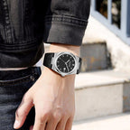 MEGIR 8406 quartz watch on the wrist, silver case, black dial and black leather strap, outdoor shot