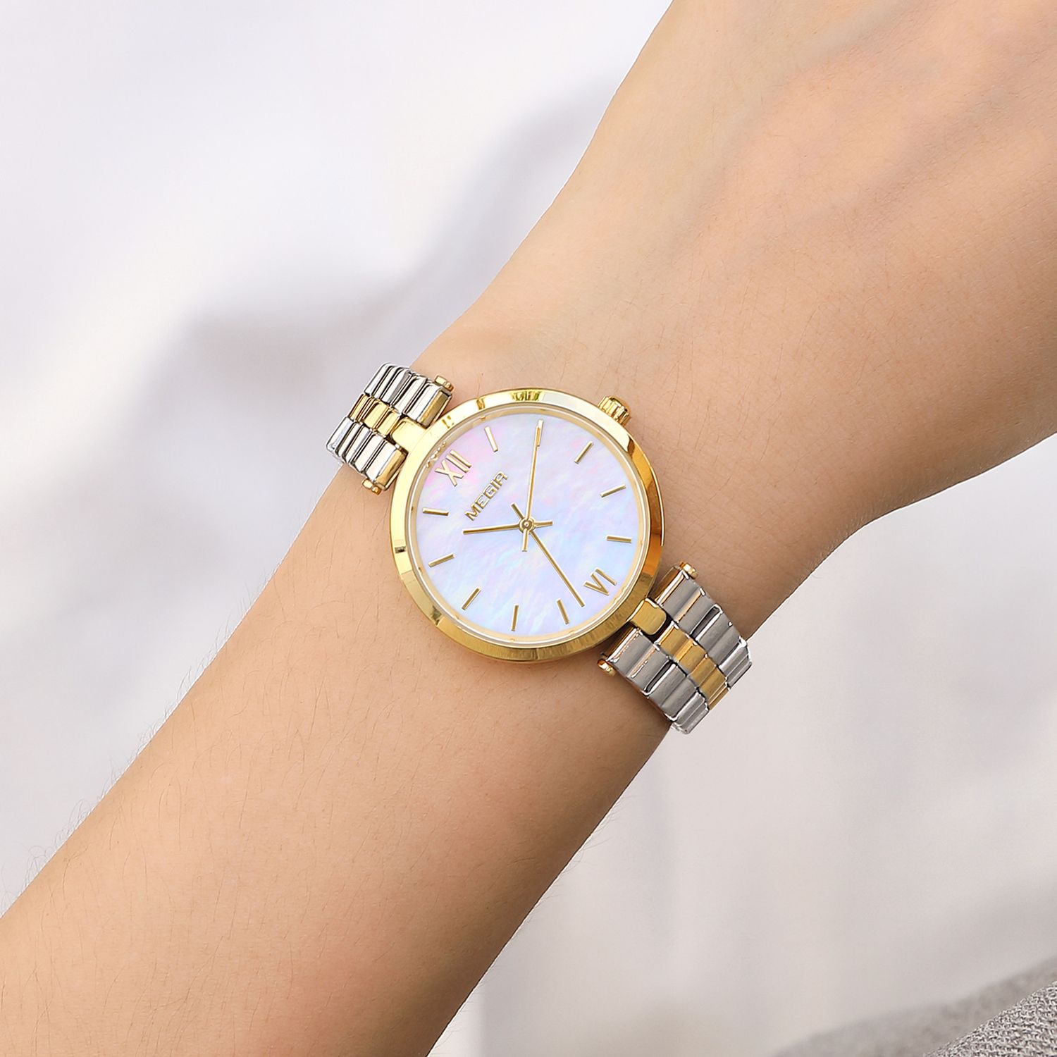 MEGIR 85112 women's quartz watch on the wrist, gold case and two-tone gold and silver steel bracelet