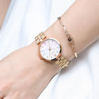 MEGIR 85112 women's quartz watch on the wrist, rose-gold case and rose-gold steel bracelet