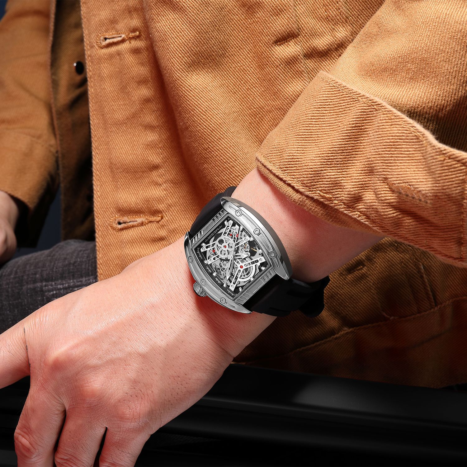 MEGIR 8601 skeleton automatic watch on the wrist, silver case, openwork dial and black silicone strap