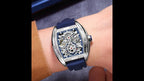 MEGIR 8601 skeleton automatic watch on the wrist, silver case and blue silicone strap, close-up