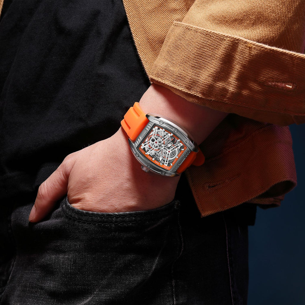 MEGIR 8601 skeleton automatic watch on the wrist, silver case, orange accents and orange silicone strap