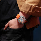 MEGIR 8601 skeleton automatic watch on the wrist, silver case, orange accents and orange silicone strap