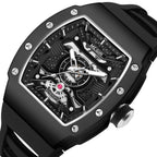 MEGIR 8604 skeleton automatic watch, black case, openwork dial and black silicone strap, angled view