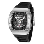 MEGIR 8604 skeleton automatic watch, silver case, openwork dial and black silicone strap, angled view