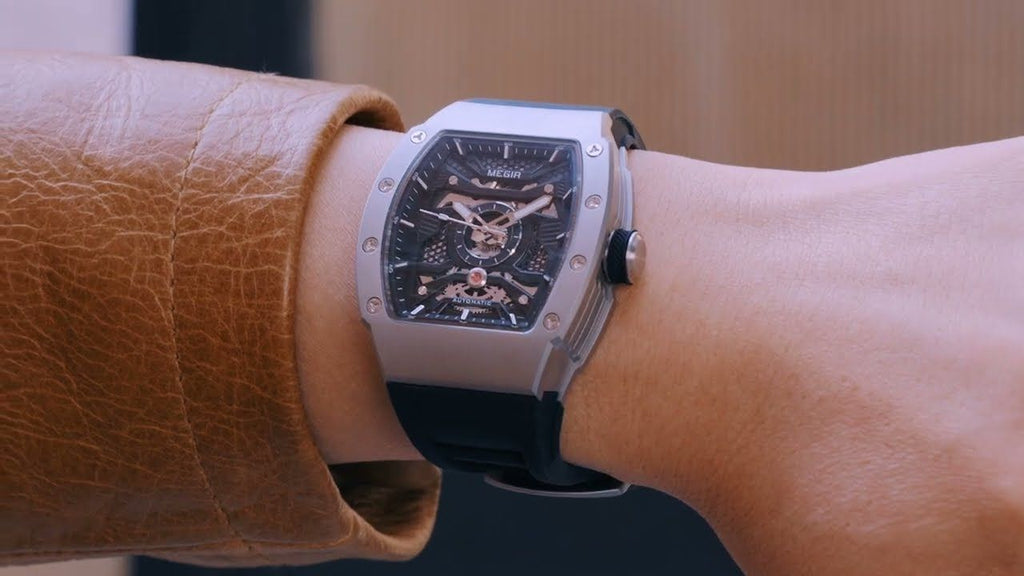 MEGIR 8604 skeleton automatic watch on the wrist, silver case and black strap, styled shot