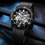 MEGIR 8605 skeleton automatic watch, black case, black bezel and black strap, blue-lit beauty shot