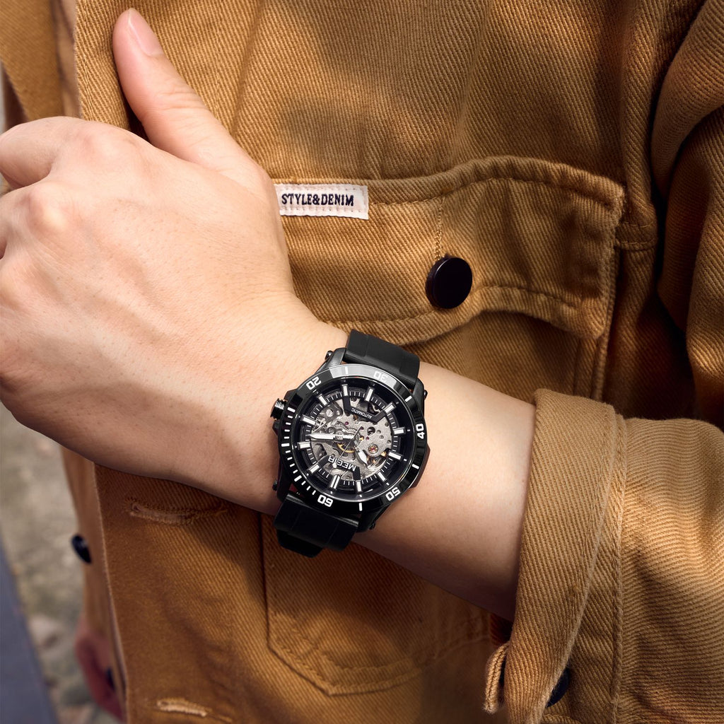 MEGIR 8605 skeleton automatic watch on the wrist, black case, black bezel and black silicone strap