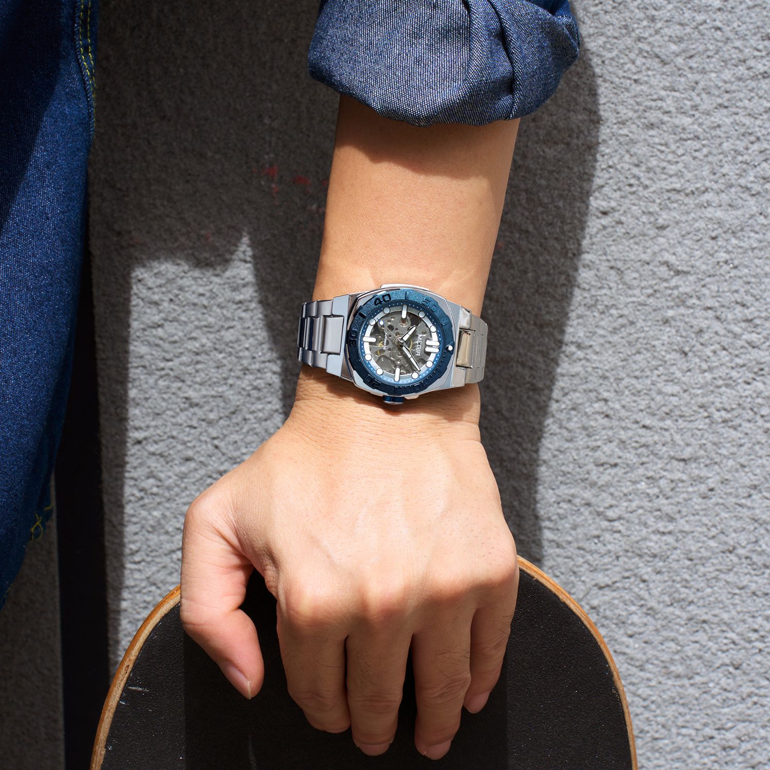 MEGIR 8606 skeleton automatic watch on the wrist, silver case, blue bezel and steel bracelet