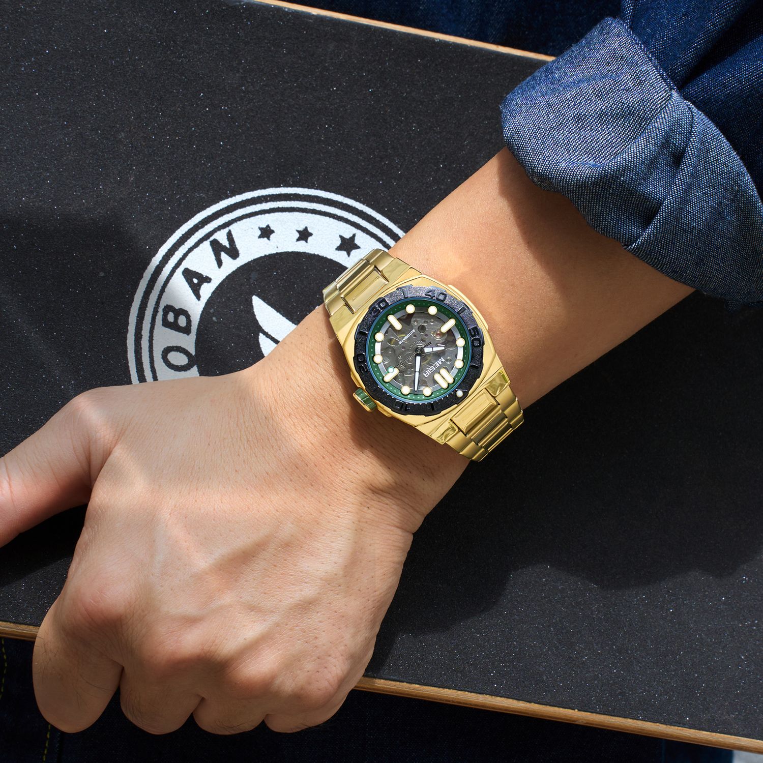 MEGIR 8606 skeleton automatic watch on the wrist, gold case, black bezel and gold steel bracelet