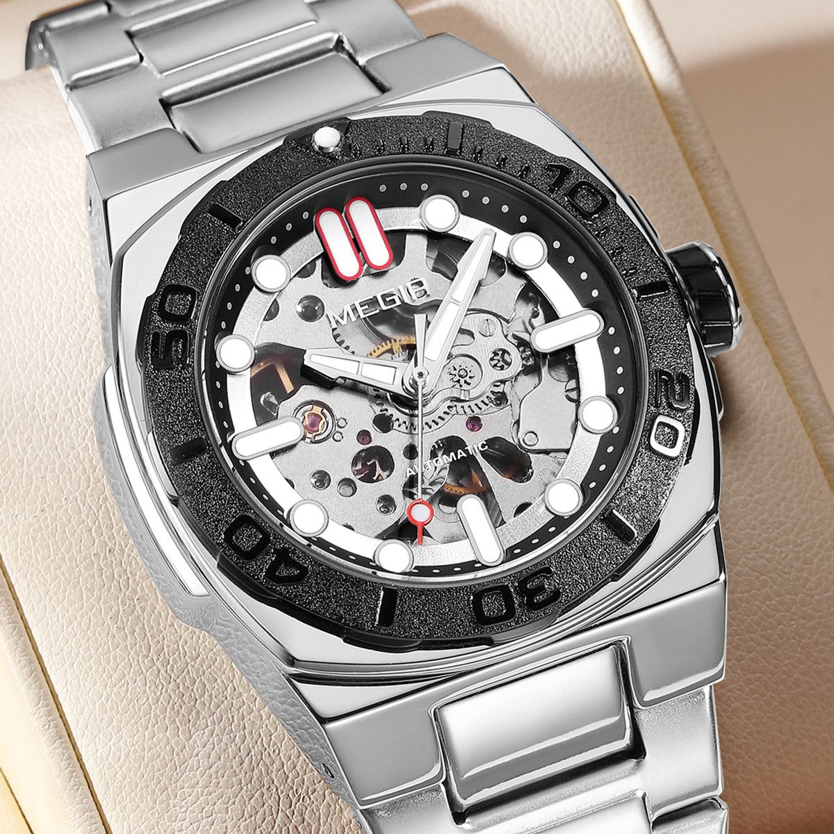 MEGIR 8606 skeleton automatic watch, silver case, black bezel and steel bracelet, close-up beauty shot