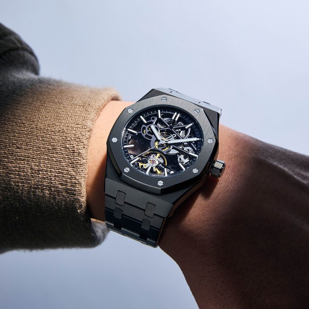MEGIR 9005-4 skeleton automatic watch on the wrist, black octagonal case and integrated black bracelet
