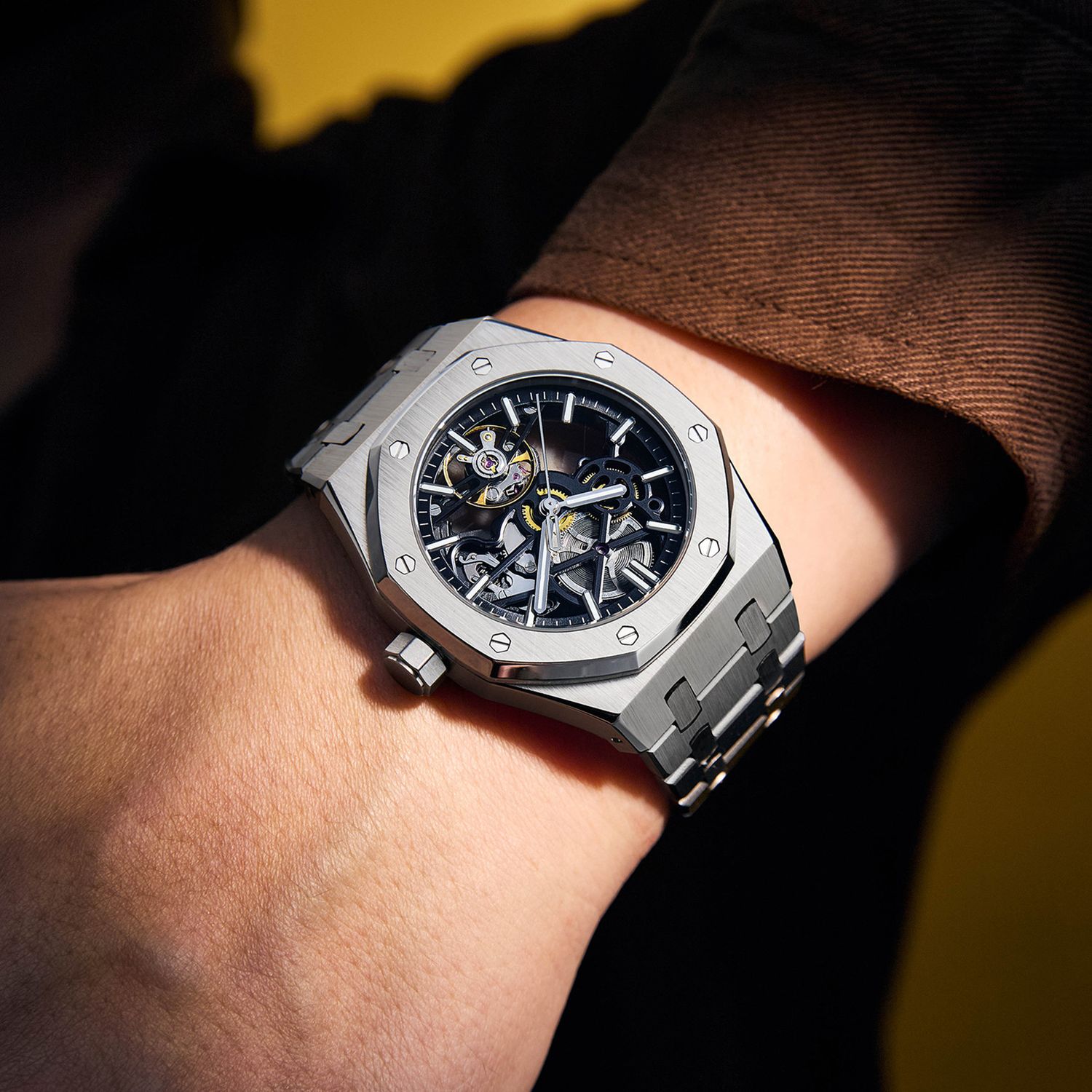 MEGIR 9005-4 skeleton automatic watch on the wrist, silver octagonal case and integrated steel bracelet