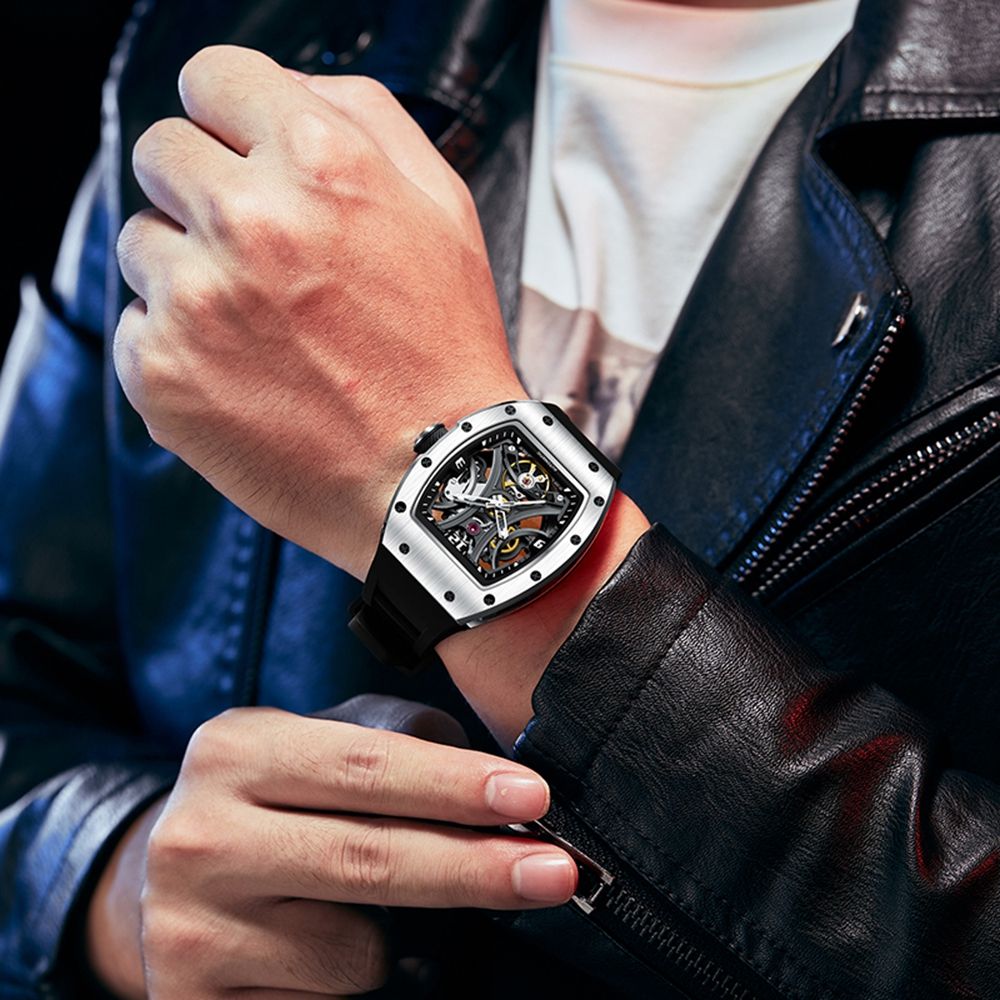 MEGIR 9190-11 skeleton automatic watch on the wrist, silver case and black silicone strap