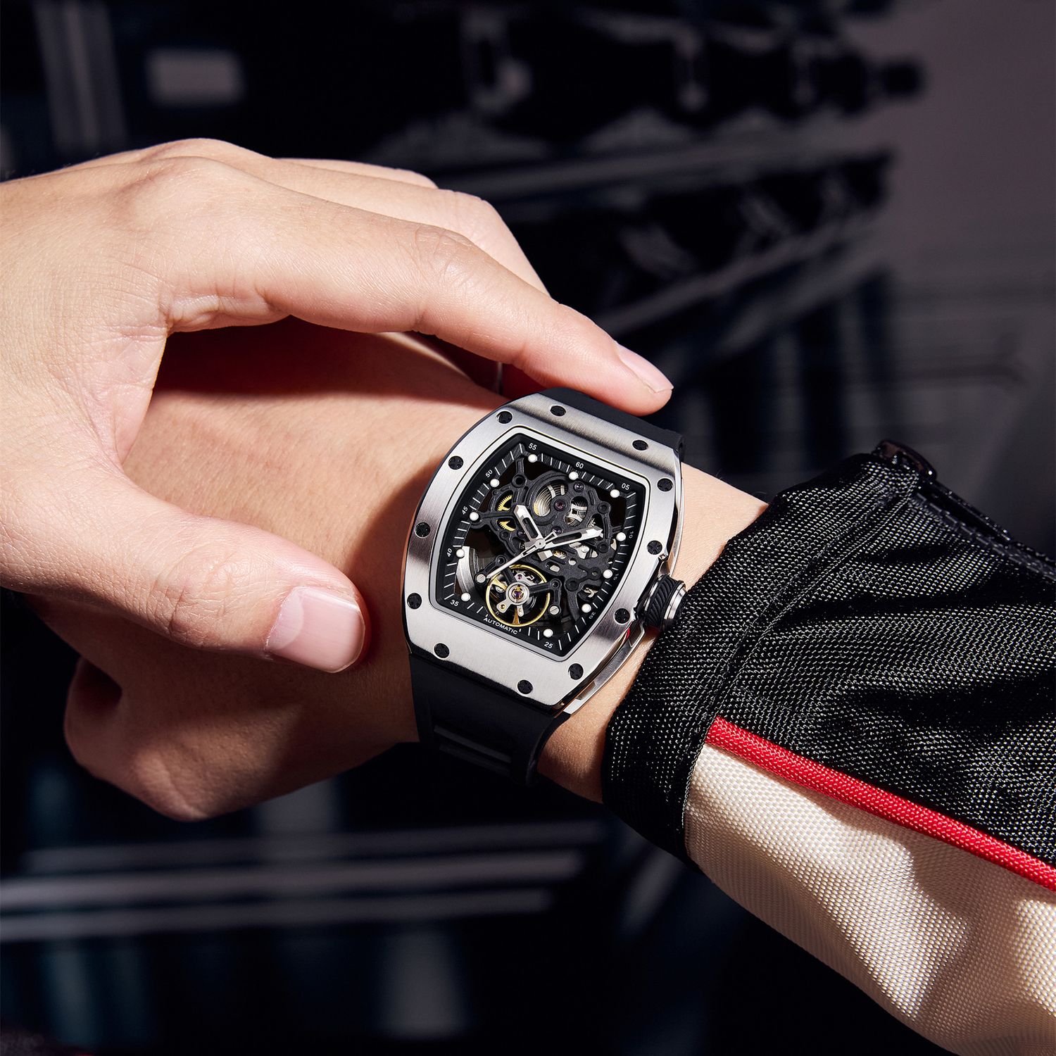MEGIR 9190-12 skeleton automatic watch on the wrist, silver case and black silicone strap