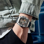 MEGIR 9190-13 skeleton automatic watch on the wrist, silver case and black silicone strap