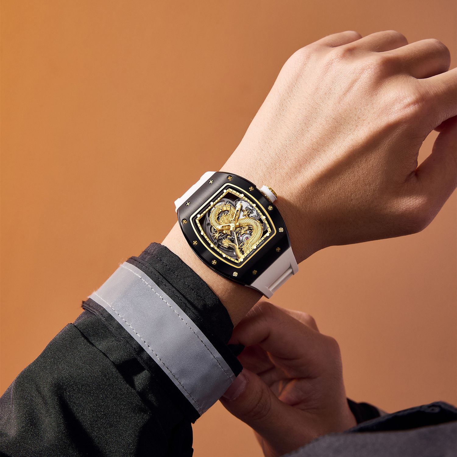 MEGIR 9190-15 dragon skeleton automatic watch on the wrist, black case, gold dragon dial and white strap