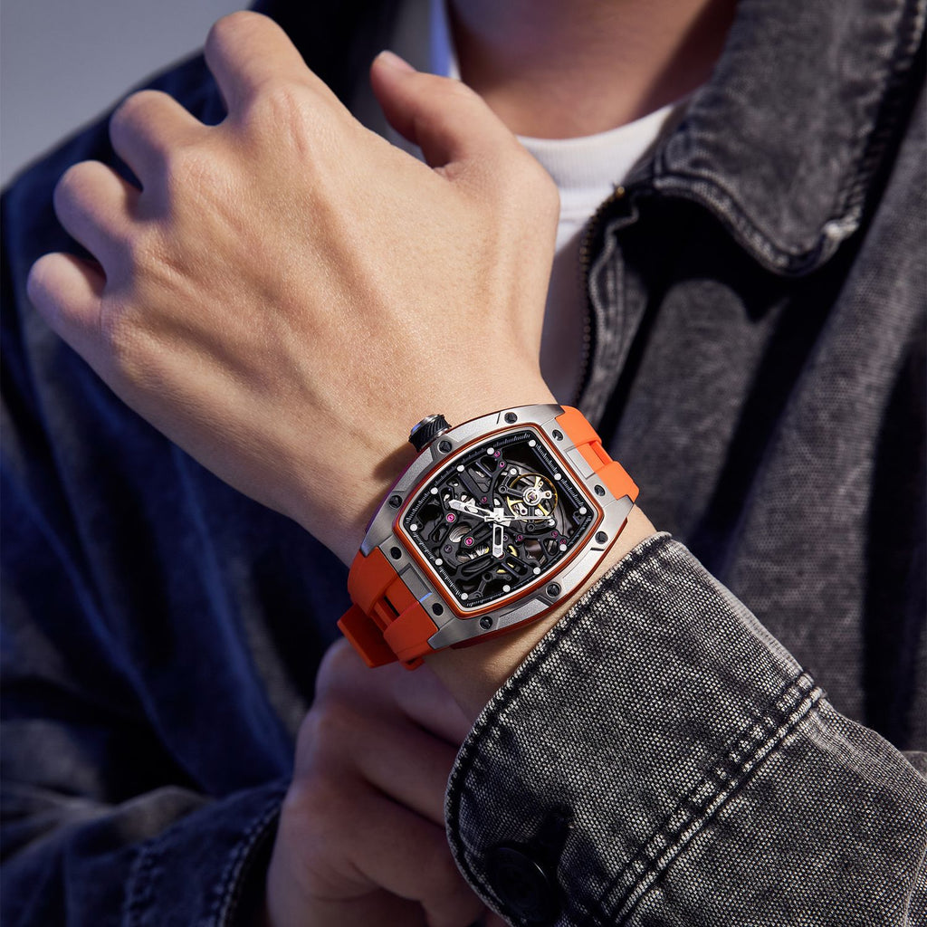 MEGIR 9198-1 skeleton automatic watch on the wrist, silver case and orange silicone strap