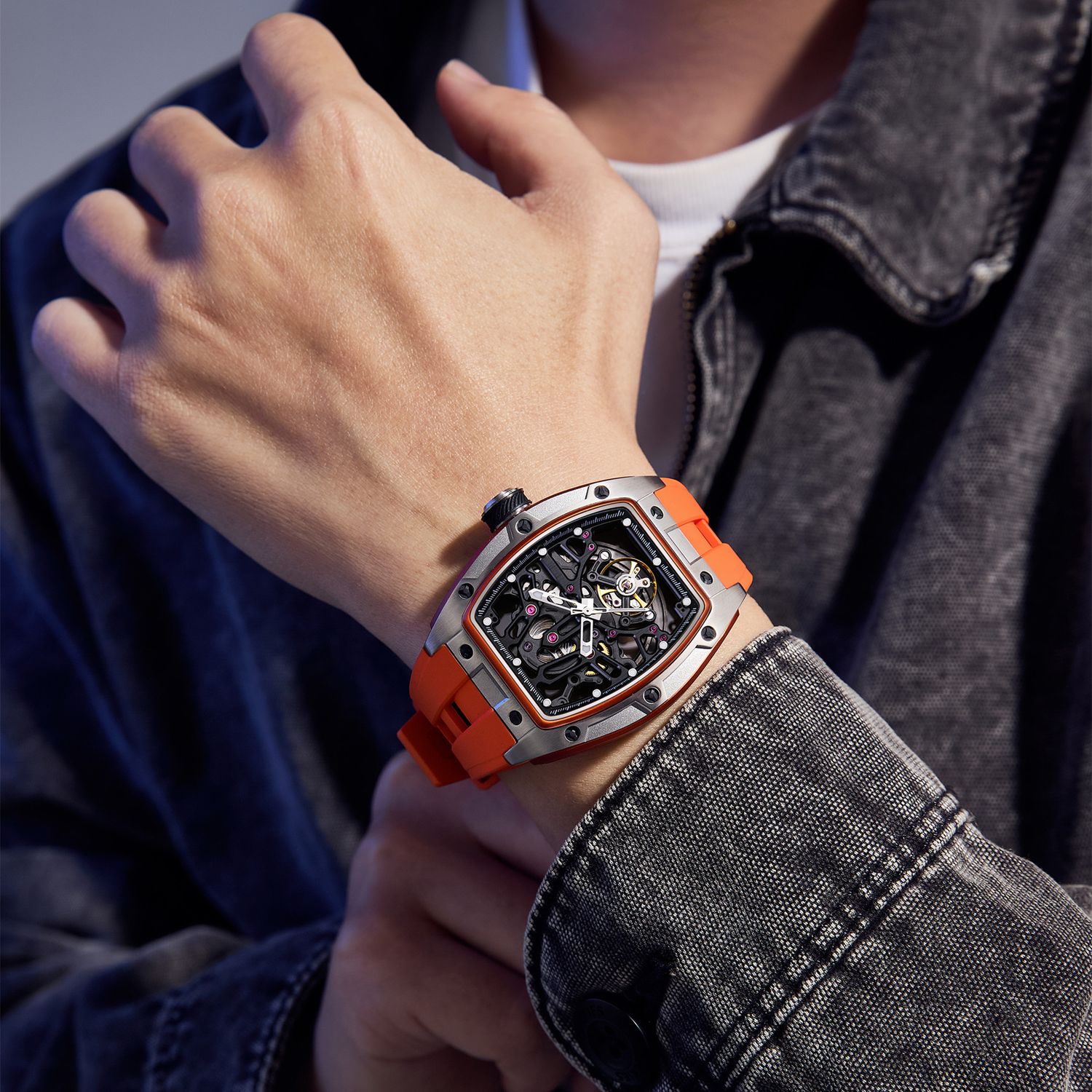 MEGIR 9198-1 skeleton automatic watch on the wrist, silver case and orange silicone strap