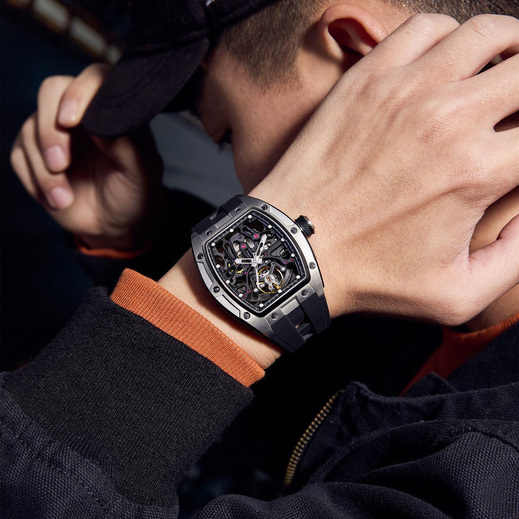 MEGIR 9198-1 skeleton automatic watch on the wrist, silver barrel case and black silicone strap