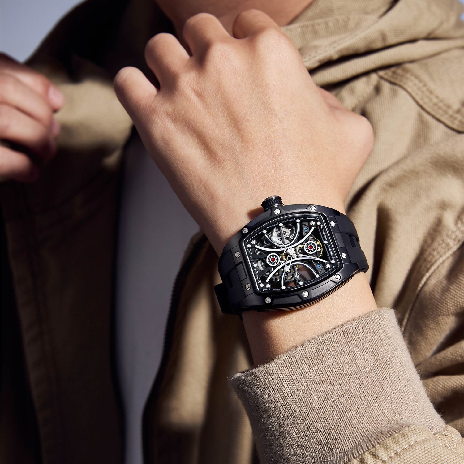 MEGIR 9198-4 skeleton automatic watch on the wrist, black case and black silicone strap