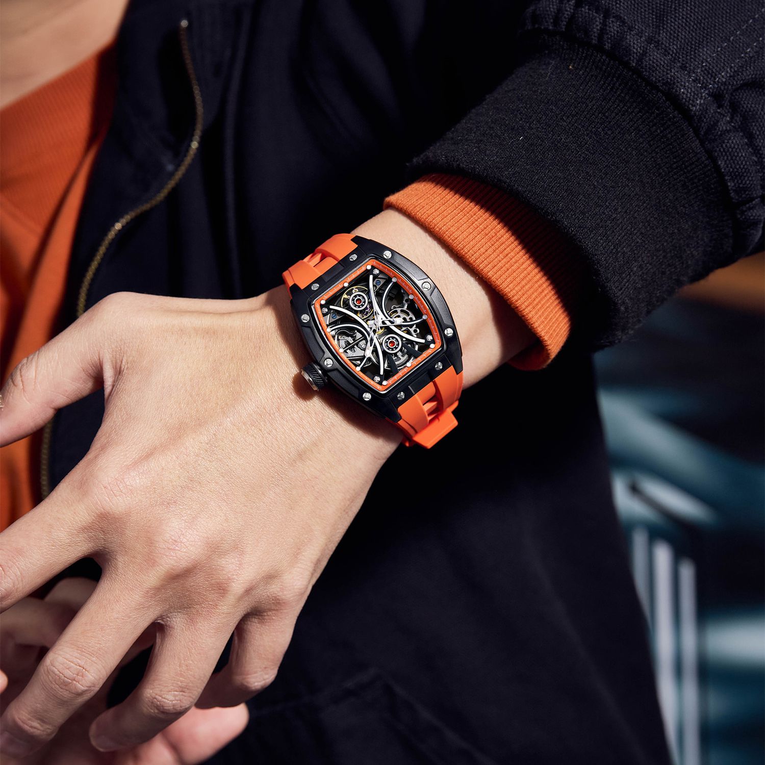 MEGIR 9198-4 skeleton automatic watch on the wrist, black case and orange silicone strap