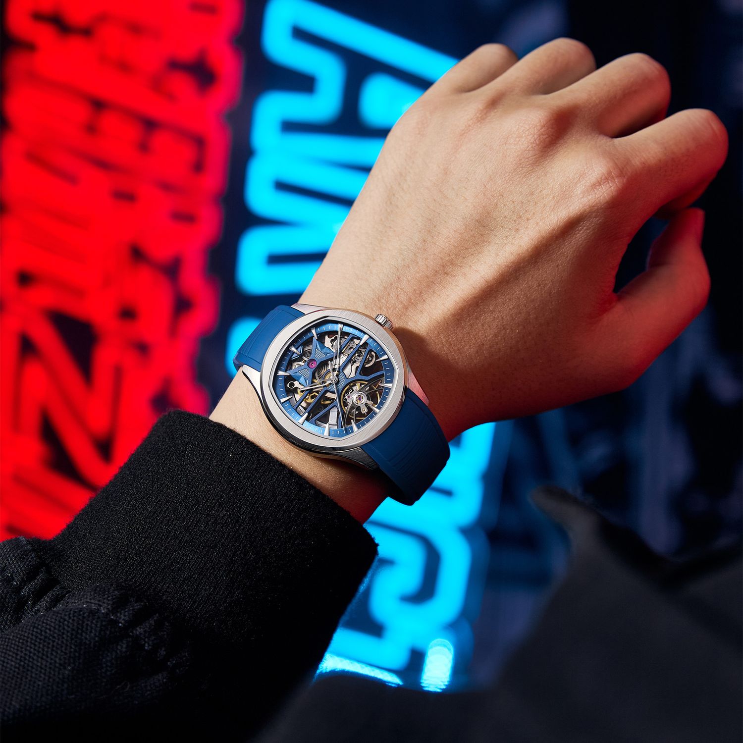 MEGIR 9204-5 skeleton automatic watch, blue dial and blue silicone strap, worn against neon lights