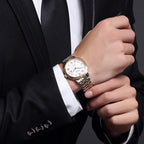 MEGIR 96001 automatic dress watch worn with a black suit and tie, two-tone steel bracelet, wrist view