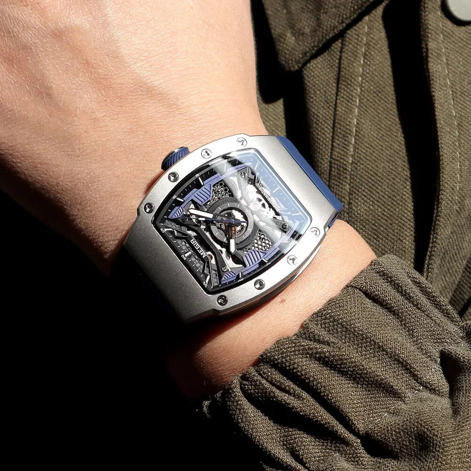MEGIR MN8603GWE-7 automatic skeleton tonneau watch with blue dial on wrist