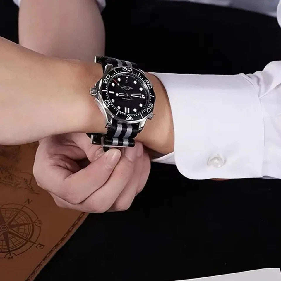 Pagani Design nylon watch strap with black and grey stripes, 20mm width, displayed on a watch worn on a wrist with a white sleeve