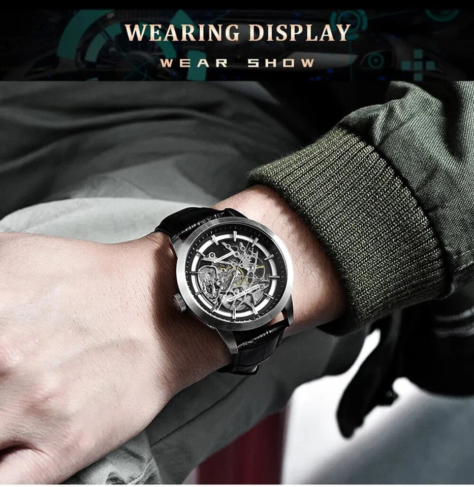 Wrist shot of Pagani Design PD-1638 skeleton automatic watch with silver case, skeletonized dial, and black leather strap, worn on a wrist with a green jacket and blurred background.