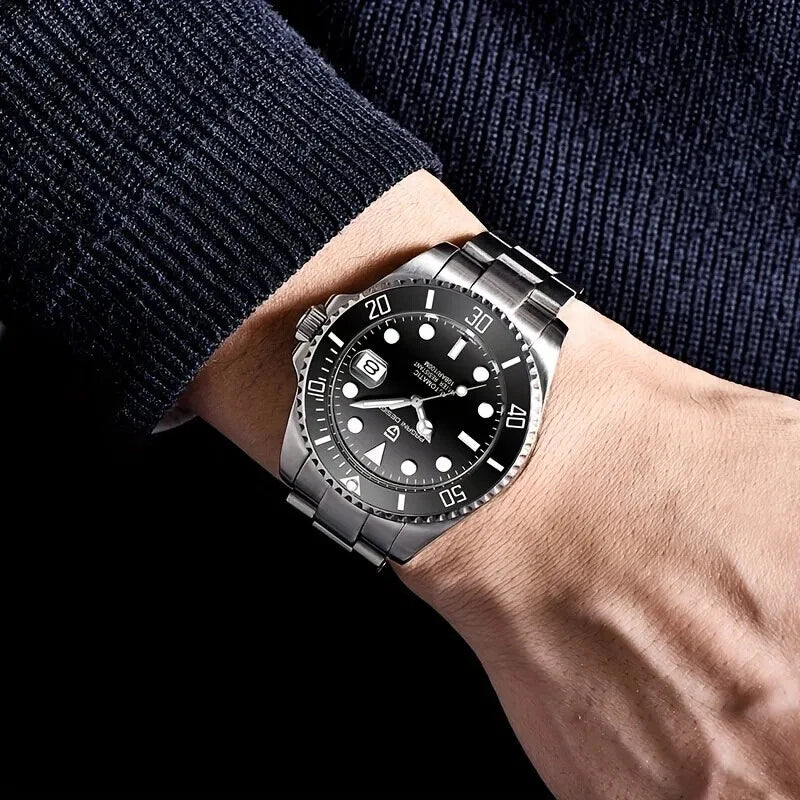 Wrist shot of Pagani Design PD-1639 mechanical automatic diver watch with black dial and stainless steel bracelet, worn on the wrist with a navy sweater.