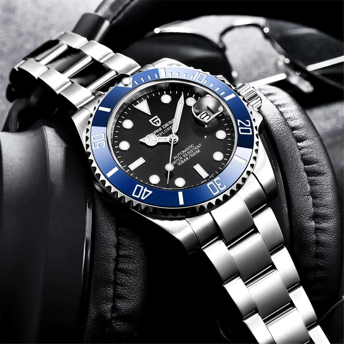 Pagani Design PD-1661 black dial blue bezel model displayed on leather headphones