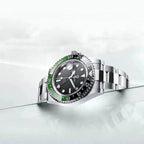 PAGANI Design PD-1662 GMT watch with black sprite bezel and steel bracelet on glass surface