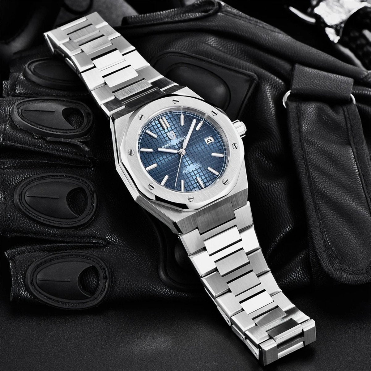 Pagani Design PD-1673 blue dial flatlay on black gloves with the steel bracelet fully extended