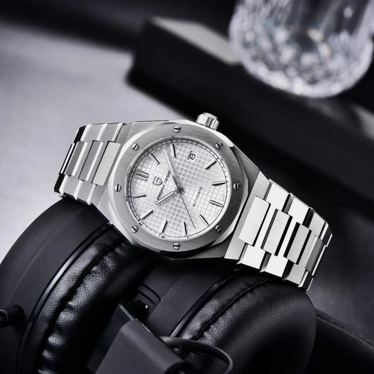 Pagani Design PD-1673 white waffle dial on headphones, light catching the polished bracelet links