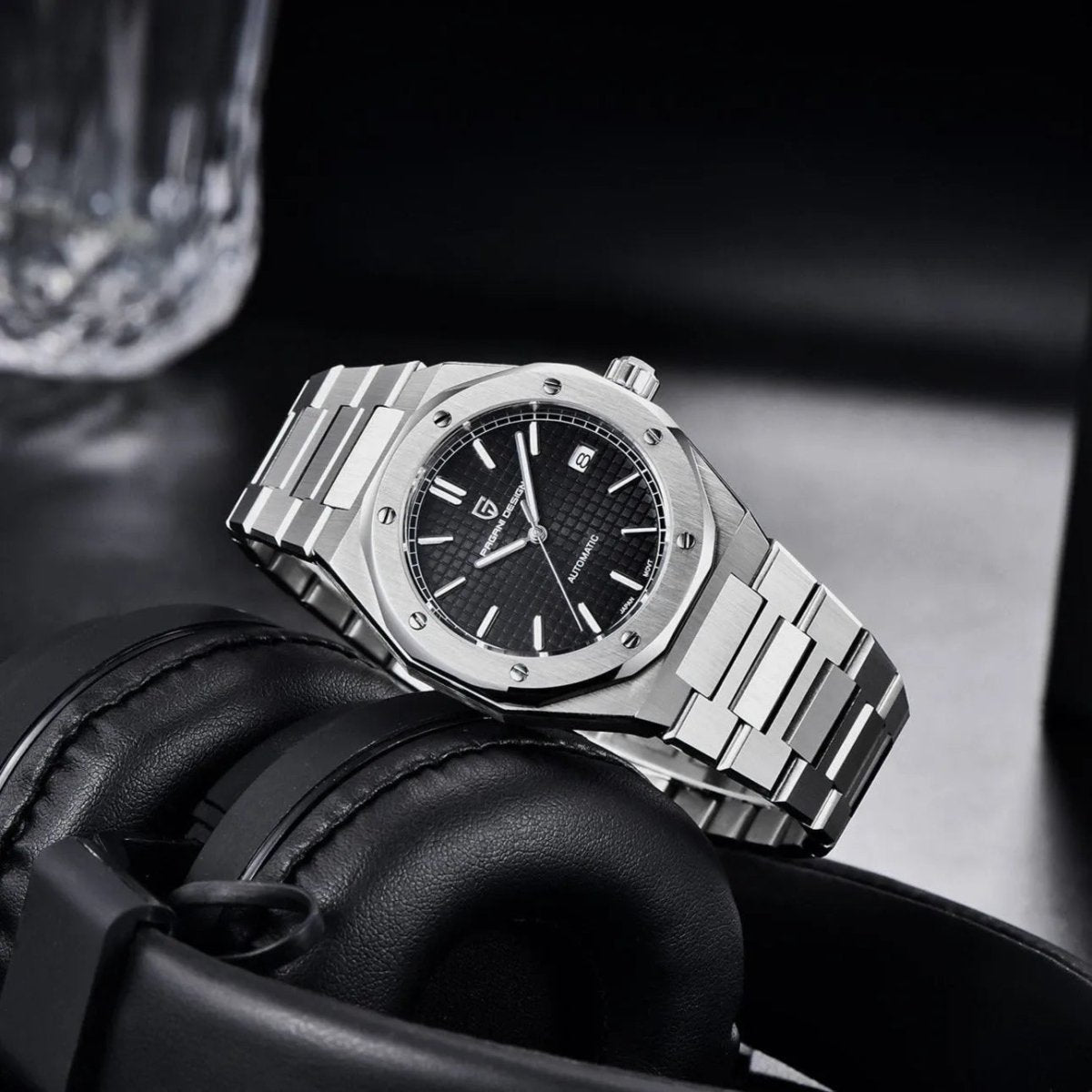 Pagani Design PD-1673 black dial angled on headphones, showing octagonal case profile and crown