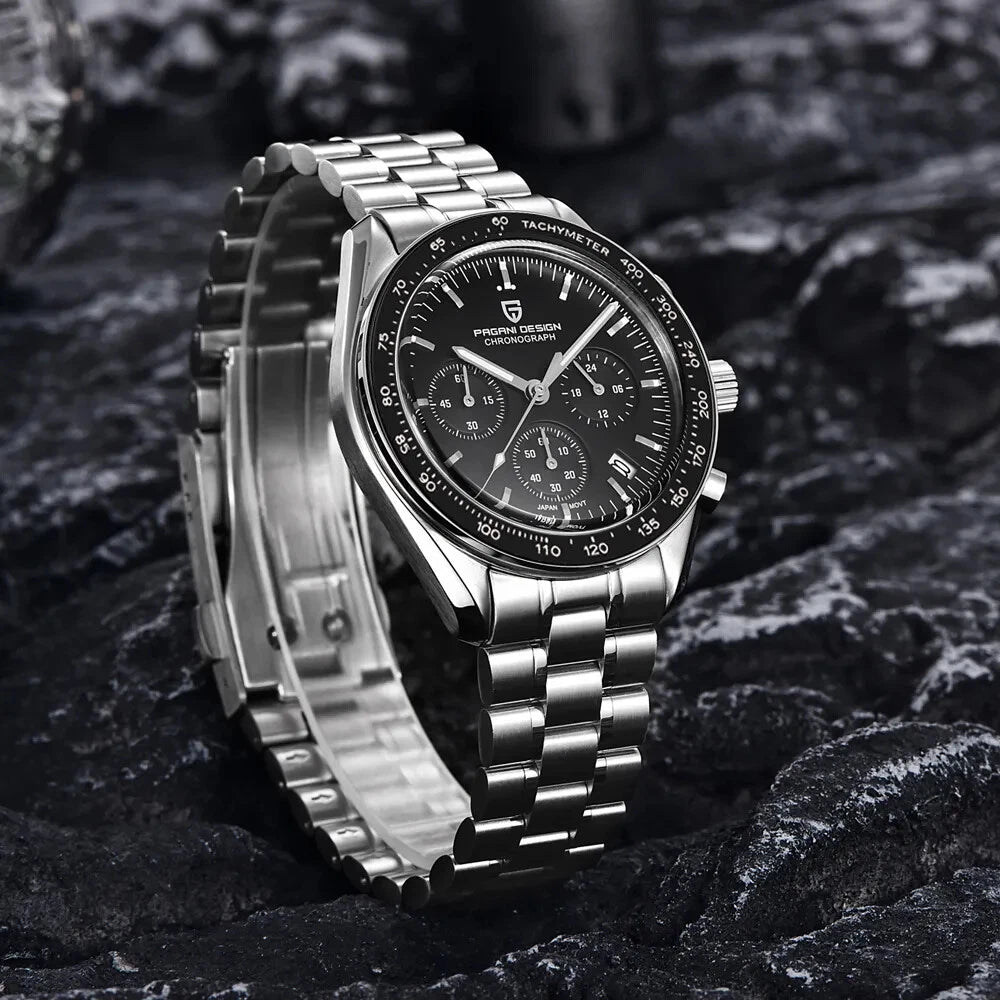 Angled view of Pagani Design PD-1701 chronograph watch with black dial, stainless steel bracelet and black tachymeter bezel on a textured surface.
