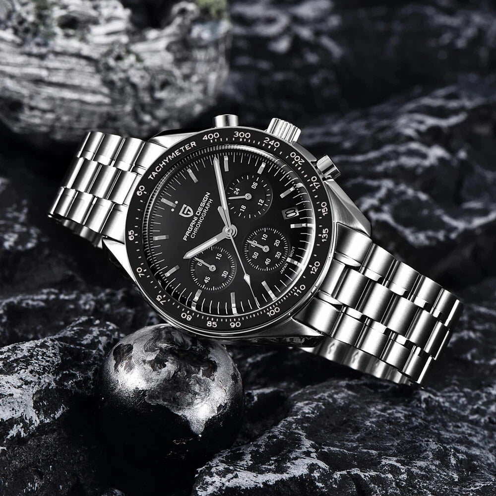 Lifestyle shot of Pagani Design PD-1701 watch with black dial, stainless steel bracelet, black tachymeter bezel, on a dark textured surface.