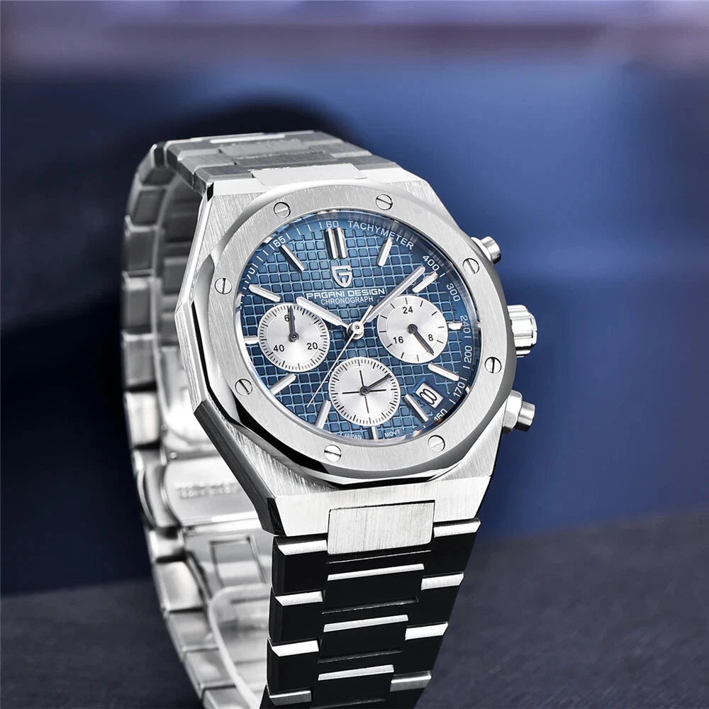 Angled upright view of Pagani Design PD-1707 chronograph quartz watch with blue dial and stainless steel bracelet on a grey display stand with blurred blue background.