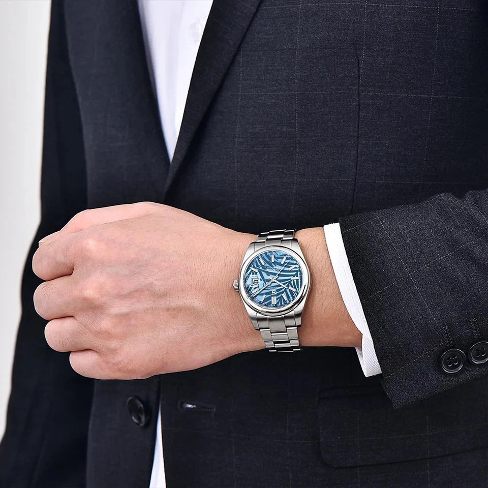 Wrist shot of Pagani Design PD 1715 automatic watch blue patterned dial stainless steel bracelet worn with dark suit jacket